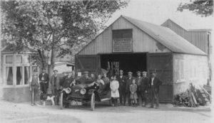 Caleb White and family (in car) at his builders yard in Church Road
